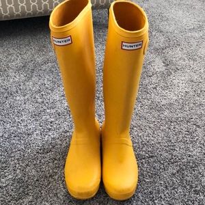 Tall rubberized hunter rain boots